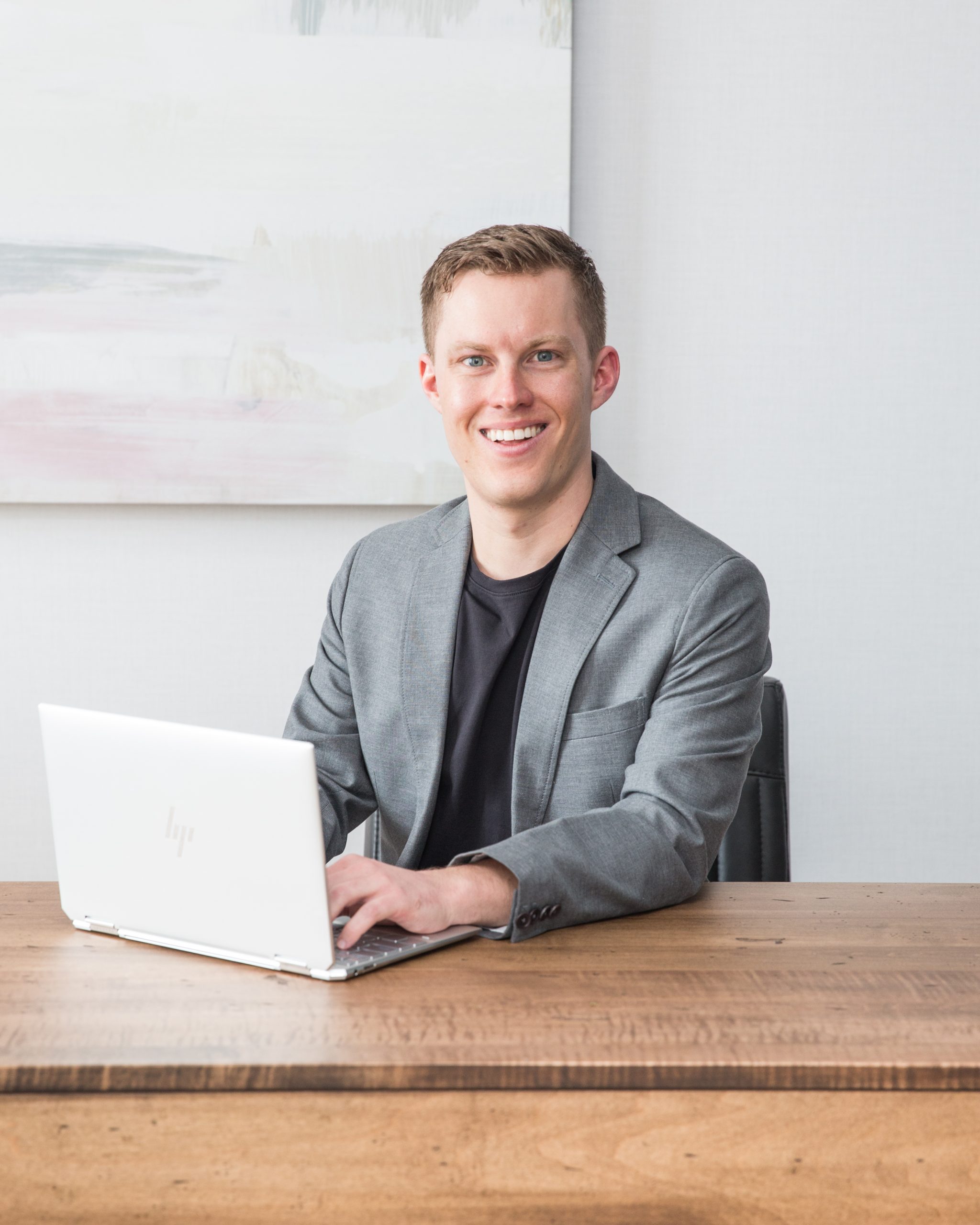 Phillip Williams, Real Estate Agent, on laptop at desk